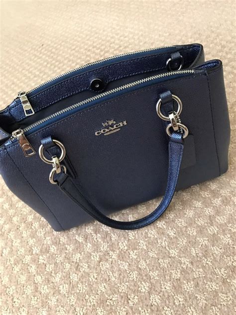 small navy blue coach purse.